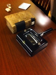 Our 1807 volume and a UV light with magnifying glass